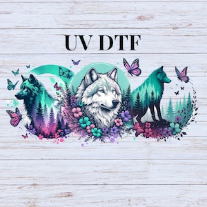 May include: A colorful graphic featuring three wolves with forest and butterfly designs. The central wolf is white, while the others are teal and green. The text "UV DTF" is at the top.