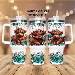 May include: Three 40 oz stainless steel tumblers with handles. Each tumbler features a different design of a Highland cow with a floral pattern in shades of teal and brown. The text "READY TO APPLY 40 oz UV DTF" is printed on the top of the image.