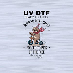 May include: A sloth riding a tricycle with a party hat and scarf. The text reads "UV DTF Ready to Apply Born to Dilly Dally * Forced to Pick * Up the Pace The Kraft Shop By Ka"