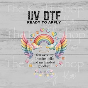 May include: UV DTF graphic with a rainbow, angel wings, and hearts. Text reads "You were my favorite hello and my hardest goodbye." Paw prints and the text "The Kraft Shop By Kari" are also included.