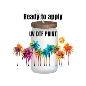 May include: A white tumbler with a wooden lid and a straw. The tumbler has a colorful palm tree design and the text "UV DTF PRINT" on the front. The text "Ready to apply" is above the tumbler.