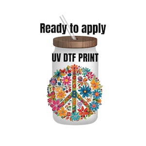 May include: A white tumbler with a wooden lid and a straw. The tumbler has a peace sign design made of colorful flowers and the text "UV DTF PRINT" on the front. The text "Ready to apply" is above the tumbler.