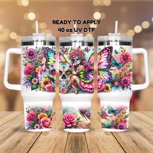 May include: Three 40 ounce stainless steel tumblers with lids and straws. Each tumbler features a different design with a sugar skull, butterfly, and floral elements. The text "READY TO APPLY 40 oz UV DTF" is printed on the top of the image.