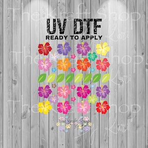 May include: A colorful UV DTF (Direct to Film) transfer design featuring vibrant hibiscus flowers in shades of red, pink, purple, orange, and yellow, with green leaves. The text "UV DTF READY TO APPLY" is displayed above the floral arrangement.