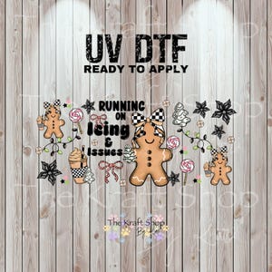 May include: UV DTF ready to apply graphic with gingerbread men, lollipops, and the text "Running on Icing & Issues." The design includes a coffee cup, bows, and Christmas tree accents. The Kraft Shop By logo is at the bottom.