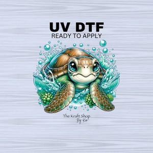 May include: A cute cartoon sea turtle with big blue eyes, surrounded by blue water and bubbles. The image has the text "UV DTF READY TO APPLY" and "The Kraft Shop By Kai" at the bottom.