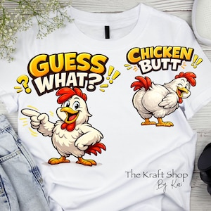 May include: White t-shirt featuring two cartoon chickens. One chicken points with the text "GUESS WHAT?" and the other chicken has the text "CHICKEN BUTT!!" The Kraft Shop by Kari is written at the bottom.