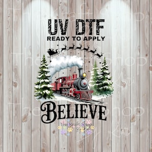 May include: A festive design featuring a red train with a black smokestack, surrounded by Christmas trees and the word "BELIEVE". Above the train, Santa's sleigh is pulled by reindeer. The text "UV DTF READY TO APPLY" is at the top.