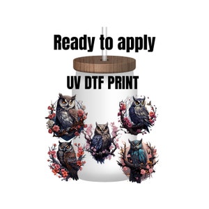 May include: White tumbler with a wooden lid and straw, featuring five owl illustrations surrounded by floral designs. The text "Ready to apply" and "UV DTF PRINT" are printed on the tumbler.