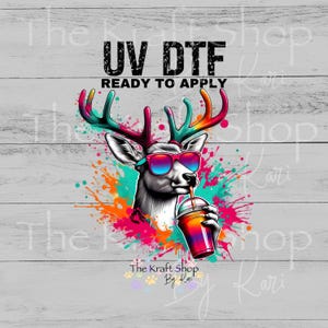 May include: A colorful UV DTF (Direct to Film) graphic featuring a deer wearing sunglasses and drinking from a vibrant cup. The design includes the text "UV DTF READY TO APPLY" and the shop name "The Kraft Shop By Kari".