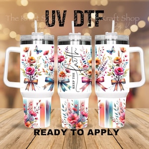 May include: Three white insulated tumblers with handles, decorated with watercolor floral designs in pink, orange, and purple. The tumblers have the words "Faith" and "Keep the" printed on them, along with the text "READY TO APPLY".