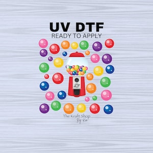 May include: A red and white gumball machine with colorful gumballs inside. The machine is surrounded by colorful gumballs. The text "UV DTF READY TO APPLY" is above the machine. The text "The Kraft Shop By Kai" is below the machine.
