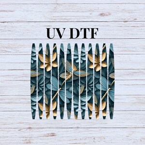 May include: A digital design featuring a repeating pattern of stylized dragonflies and flowers in teal and gold. The text "UV DTF" is printed in black at the top of the image. The design is set against a white wood grain background.