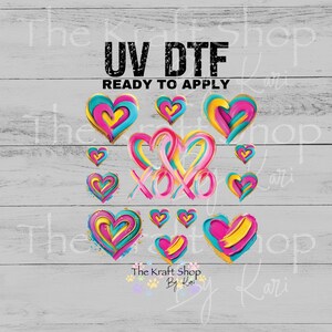 May include: UV DTF ready to apply transfers featuring colorful, abstract hearts in shades of pink, yellow, and teal. The design includes the text "XOXO" and the shop name "The Kraft Shop By Kari".