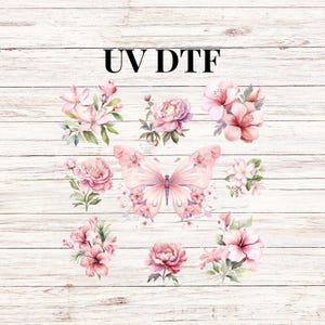 May include: A set of pink floral and butterfly designs on a white wood background. The text "UV DTF" is at the top of the image.
