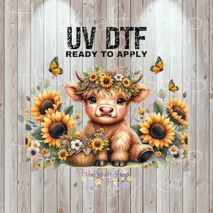 May include: A digital graphic featuring a Highland cow calf with a floral crown, surrounded by sunflowers and butterflies. The text "UV DTF READY TO APPLY" is at the top. The Kraft Shop By Lori logo is at the bottom.