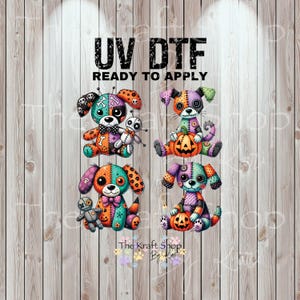 May include: UV DTF ready to apply transfer featuring four colorful, stitched-together dog designs with Halloween themes. Each dog has a unique color scheme, holding pumpkins or voodoo dolls. The Kraft Shop By... logo is at the bottom.