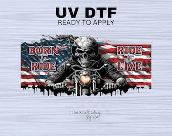 May include: UV DTF ready to apply graphic featuring a skull biker riding a motorcycle in front of an American flag. The words "Born to Ride" and "Ride to Live" are displayed. The Kraft Shop By Kai logo is at the bottom.