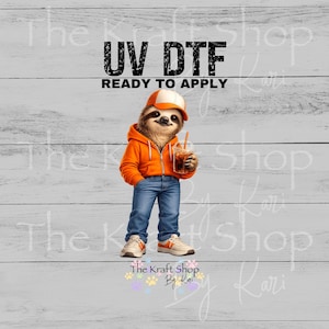 May include: UV DTF ready to apply graphic featuring a cartoon sloth wearing an orange hoodie, jeans, and a cap, holding an iced drink. The sloth is standing on a white wooden background. The Kraft Shop By Kari logo is at the bottom.