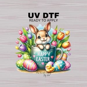 May include: A blue mug with the text "Happy Easter" and hearts around it. A cute bunny rabbit is peeking out of the mug. The mug is surrounded by colorful Easter eggs and a bouquet of yellow, pink, and purple tulips.