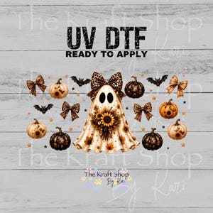 May include: A UV DTF transfer sheet featuring a central ghost character wearing a leopard print bow and holding a sunflower bouquet. The design includes various pumpkins, leopard print bows, bats, and small stars scattered across the layout.