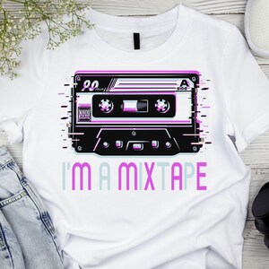 May include: White t-shirt with a graphic of a vintage cassette tape with the text "I'm a mixtape" printed below it.