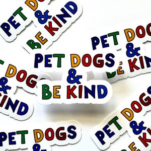 May include: A collection of colorful stickers with the text "Pet Dogs & Be Kind" in various color combinations. The stickers are on a white background.