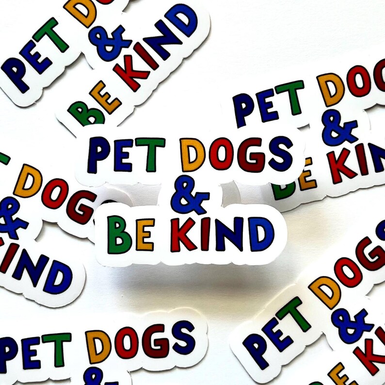 May include: A collection of colorful stickers with the text "Pet Dogs & Be Kind" in various color combinations. The stickers are on a white background.