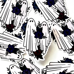 May include: A set of stickers featuring white ghosts holding bouquets of dark blue and burgundy flowers. The ghosts are outlined in black and have simple facial features. The stickers are perfect for adding a spooky touch to any surface.