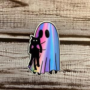May include: A holographic sticker of a ghost holding a black cat. The ghost is a light blue, pink, and purple color.