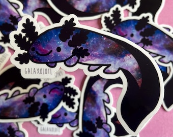 May include: A set of galaxy axolotl stickers. The axolotls are illustrated in a cartoon style with a galaxy print. The stickers are printed on white vinyl and have a glossy finish.