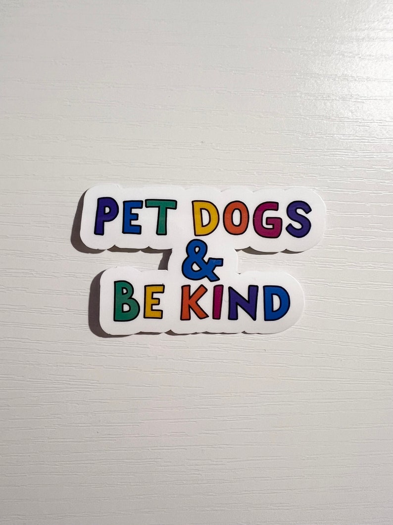 May include: A white sticker with the text "Pet Dogs & Be Kind" in rainbow colors.