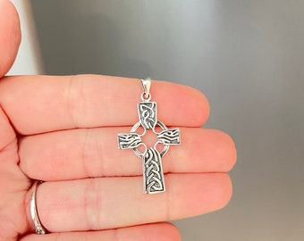 May include: A silver Celtic cross pendant with intricate knotwork design.