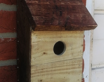 Bird house or nesting box handmade from recycled wood