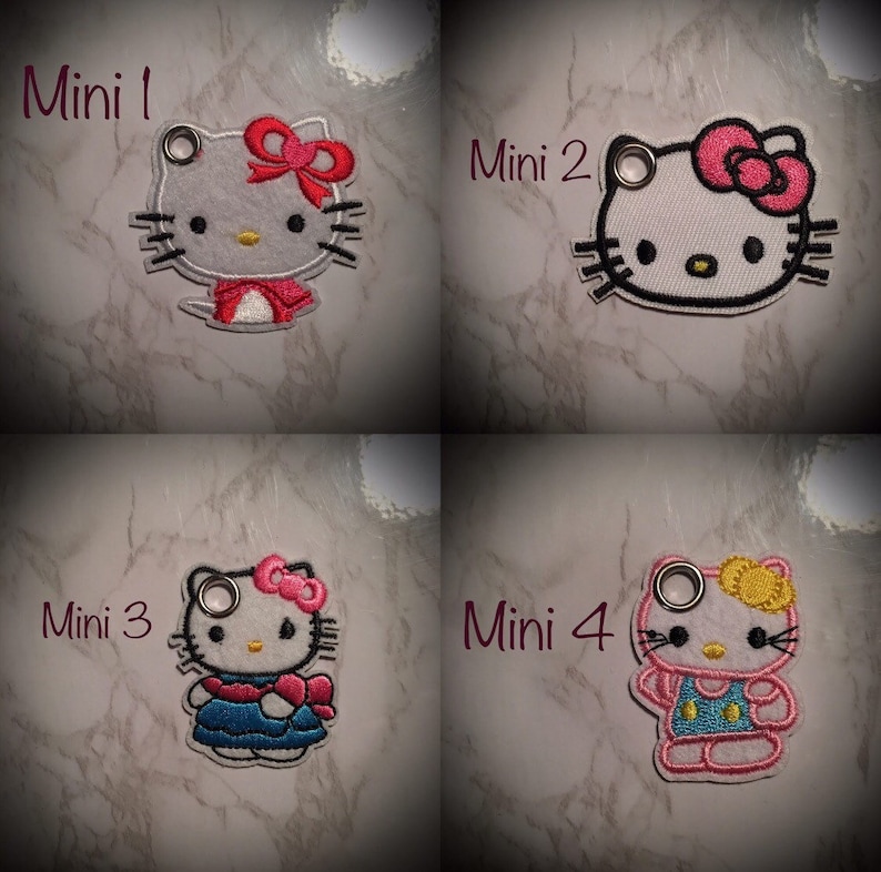 May include: Four embroidered Hello Kitty keychains with different outfits. The keychains are labeled "Mini 1", "Mini 2", "Mini 3", and "Mini 4".