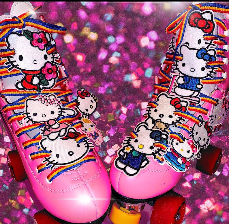 May include: Pink roller skates with rainbow laces and Hello Kitty character patches. The skates have a white base and pink wheels.