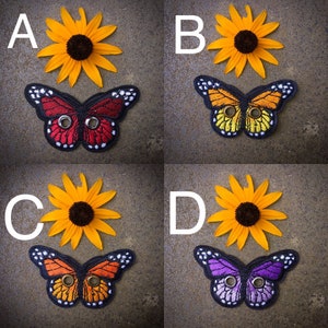 Peut inclure: Quatre motifs de papillons diff&eacute;rents avec des ailes noires, rouges, jaunes et violettes. Chaque papillon a deux boutons noirs sur ses ailes. Les papillons sont dispos&eacute;s en grille avec un tournesol derri&egrave;re chaque papillon.