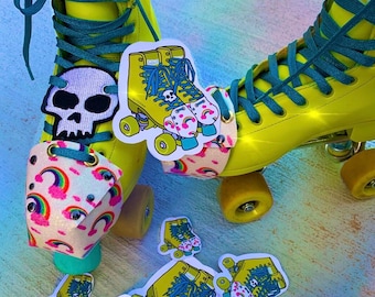 May include: Yellow roller skates with teal laces and rainbow and skull themed patches. The skates are on a blue and purple background.