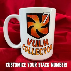 May include: White ceramic mug with a black and orange logo that says "Vuln Collector" and a number "7".