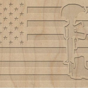 May include: A wooden American flag with a silhouette of a soldier in a fallen soldier pose. The soldier is holding a rifle and has a boot on the ground.