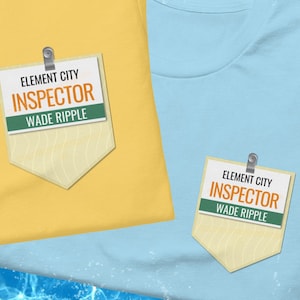 Op de afbeelding: Twee T-shirts, een gele en een blauwe, elk met een badge waarop staat "Element City Inspector Wade Ripple".