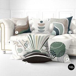 May include: Six different throw pillows with abstract designs in shades of green, brown, and white. The pillows are arranged on a white couch.