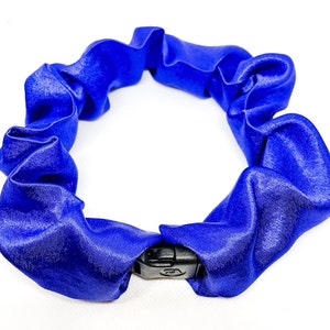 May include: A blue satin scrunchie with a black plastic clasp.