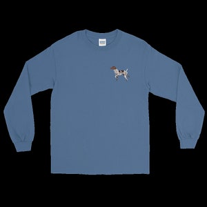 May include: A long-sleeved, light blue t-shirt with a small embroidered image of a brown and white dog on the left chest.