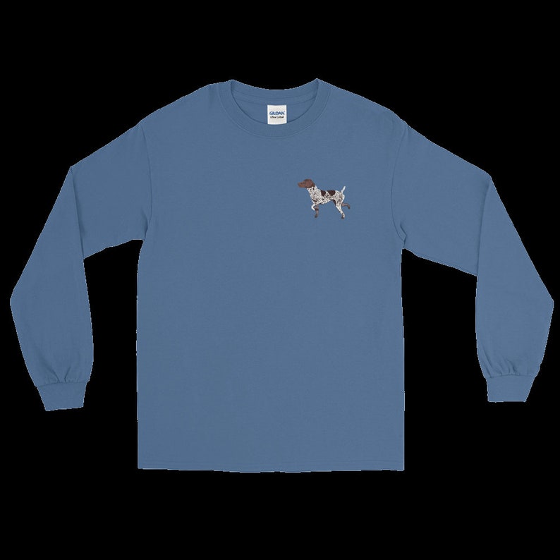 May include: A long-sleeved, light blue t-shirt with a small embroidered image of a brown and white dog on the left chest.
