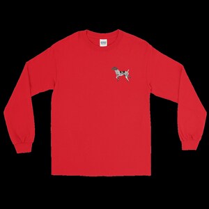 May include: Red long-sleeve t-shirt with a small embroidered image of a black and white dog on the left chest.