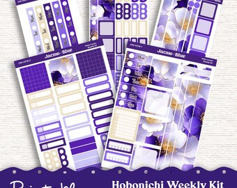 Op de afbeelding: Printbare Hobonichi Weekly Kit-stickers in paars, wit en goud. De set bevat een verscheidenheid aan stickers voor het plannen en versieren van je planner. De stickers hebben een bloemmotief met paarse bloemen en gouden accenten.