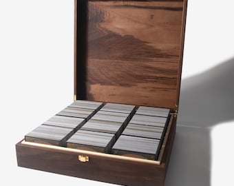 May include: A wooden box with a hinged lid, open to reveal rows of cards stacked inside. The box is made of dark wood with a natural grain pattern.