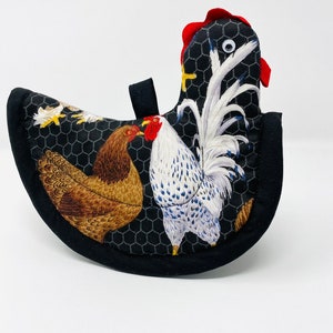 May include: Black and white chicken pot holder with a rooster, hen, and chicks on a black background with a white chicken wire pattern.