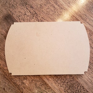 May include: A blank, light brown, wooden sign with rounded edges. The sign is made of unfinished wood and has a smooth surface.